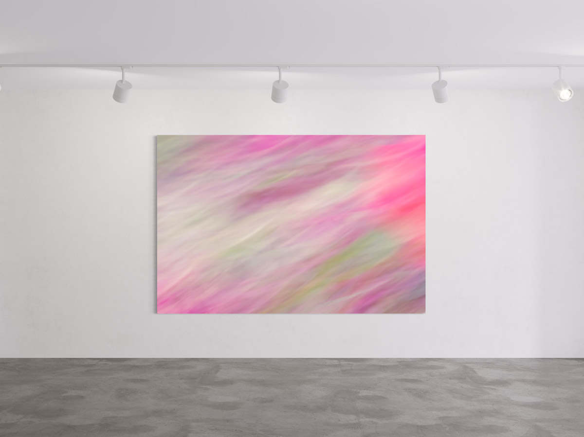 A large painting of pink and green colors hanging on the wall.
