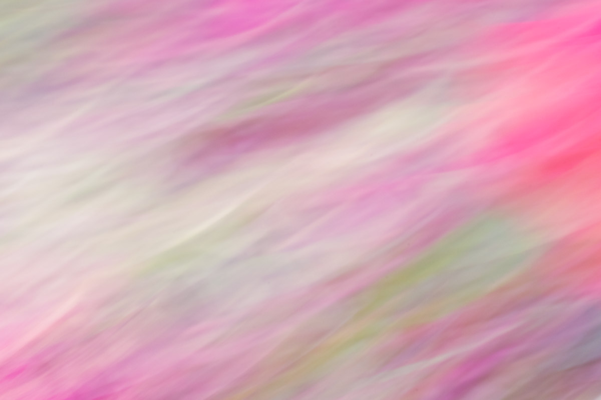 A pink and green abstract background with blurry lines.