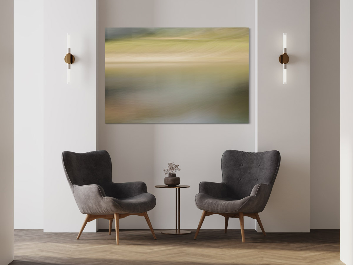 Two chairs and a table in front of a painting.