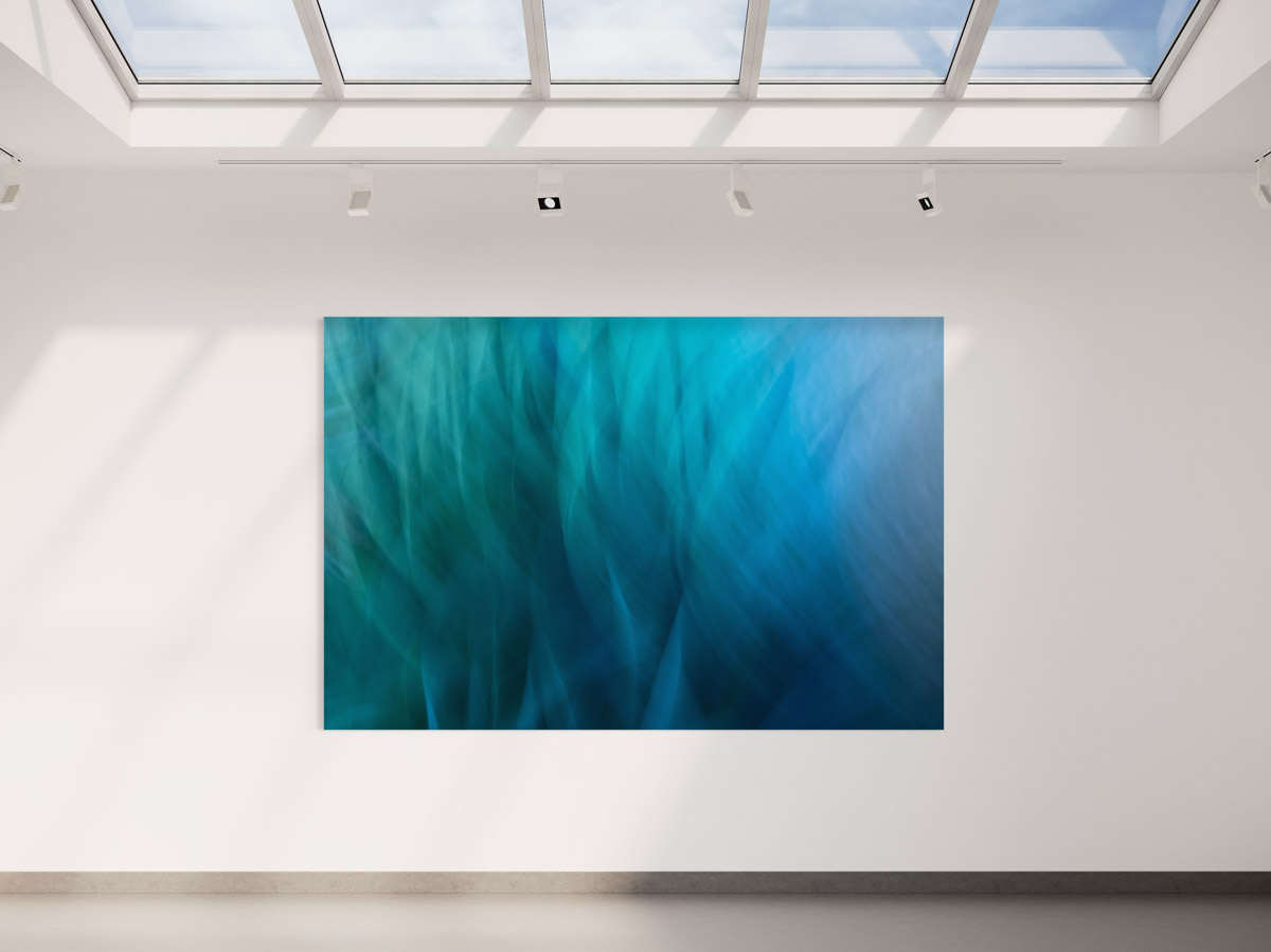 A large painting of blue water in the middle of a room.