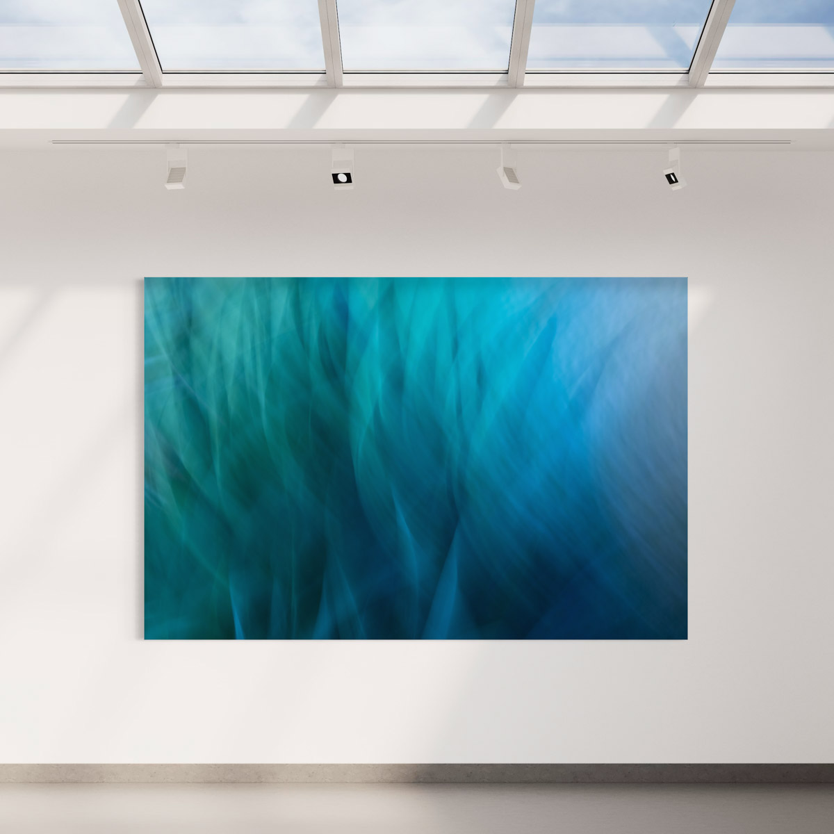 A large painting of blue water in a room.