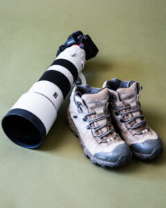 A pair of shoes and a camera lens.