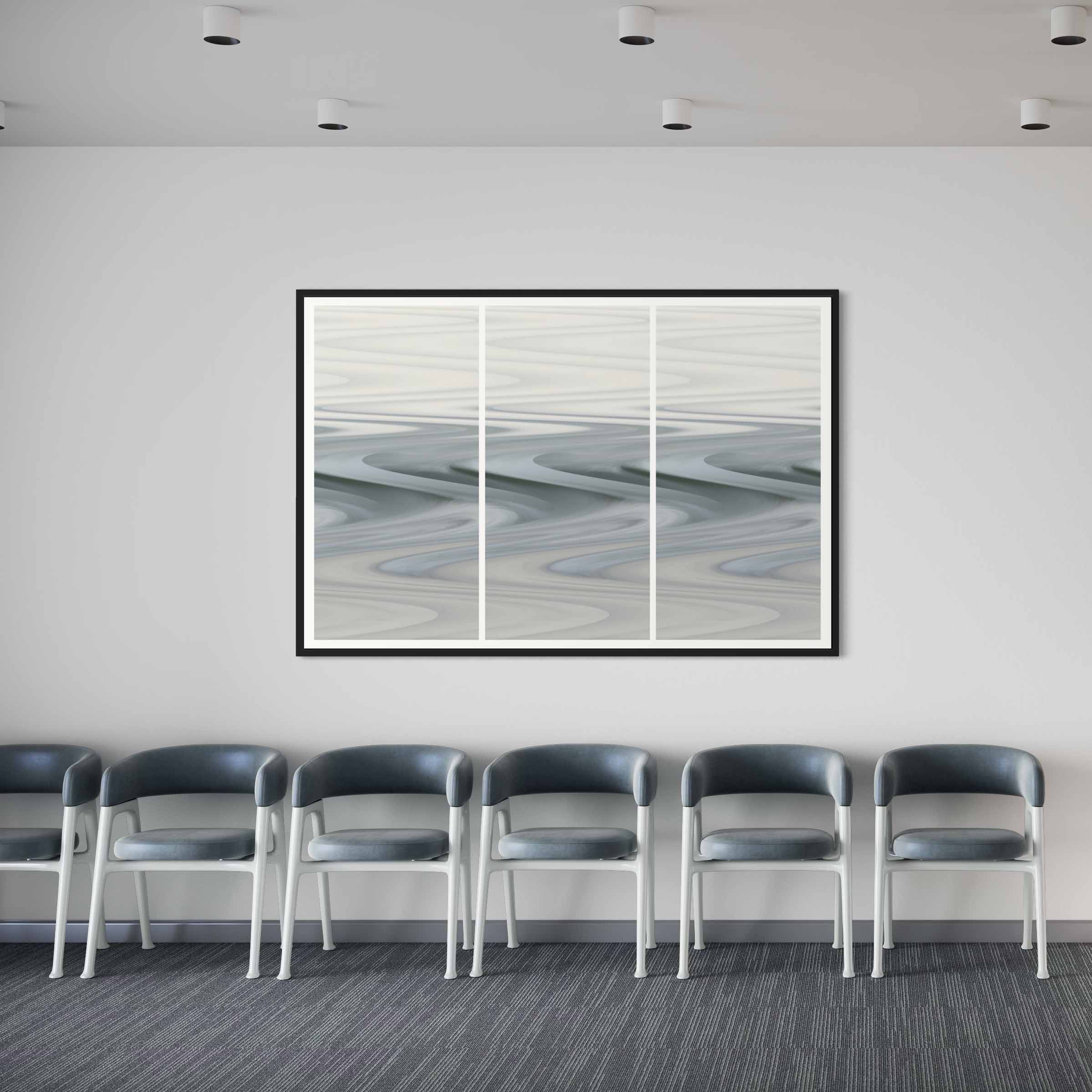 A row of chairs in front of a wall with a picture hanging on it.