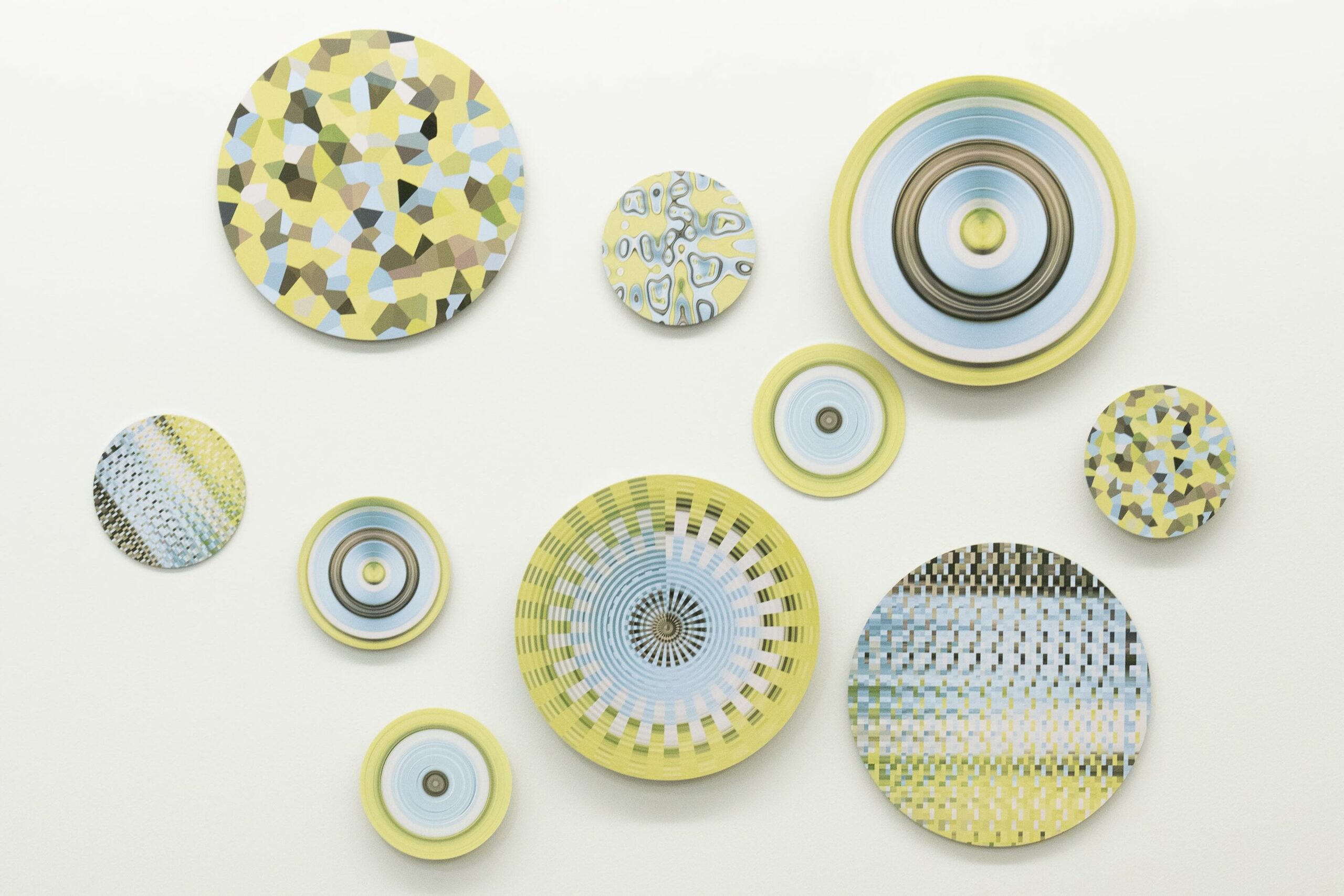 A group of yellow and white plates on the wall.